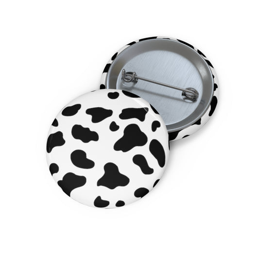 Classic black and white cow print on a button pin