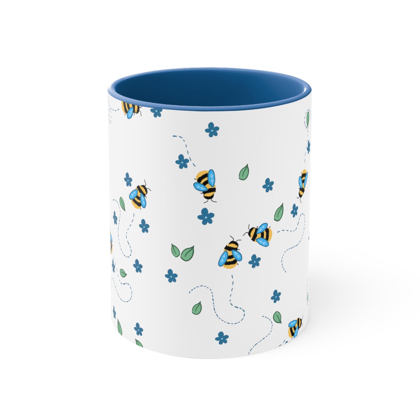 Cartoon bees With broken line trails behind them, Dark blue flowers, Loose green leaves In an all over pattern on top of a white background. The inside of the mug, and the handle is a medium dark blue color