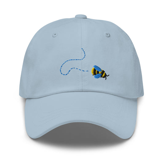 Light blue baseball cap with embroidered cartoon Bee and broken line trail behind it