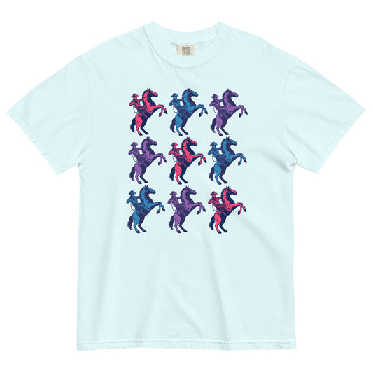 Bright, light blue shirt With cowboys on rearing horses. Three of them down three of them across alternating in colors. The colors of the cowboy and horses are hot pink, teal blue, and purple.